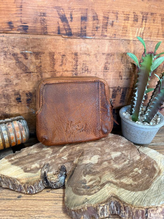 Brown cowhide double-zip coin wallet with top zip edges and compact square shape