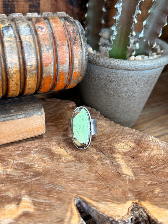 Adjustable oval stone ring with light green chrysoprase in silver-tone bezel