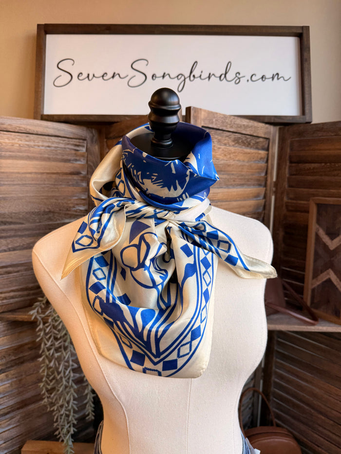 Wild rag scarf in navy and cream with bold central figure, zigzags, and border print