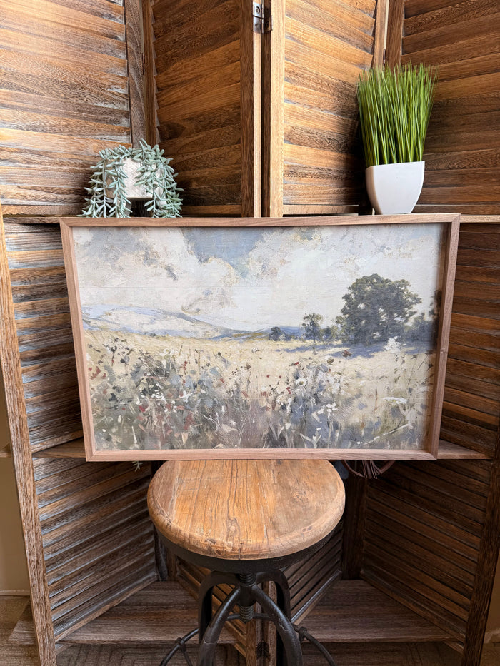 Framed landscape artwork with dusty prairie wildflowers and trees