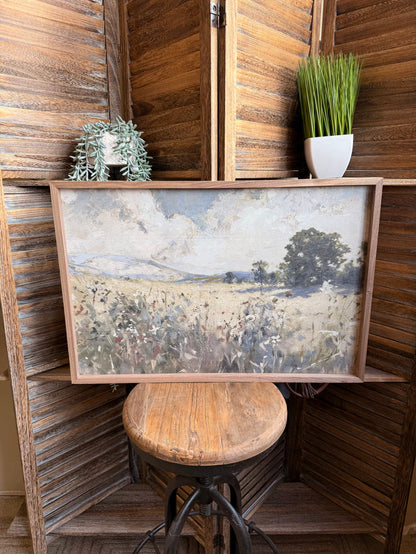 Framed landscape artwork with dusty prairie wildflowers and trees