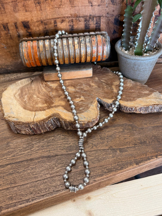 Loop pearl necklace with long strand and teardrop bead pendant, silver-tone accents