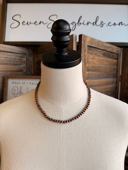 16-inch pearl bead necklace with copper-toned beads on mannequin display