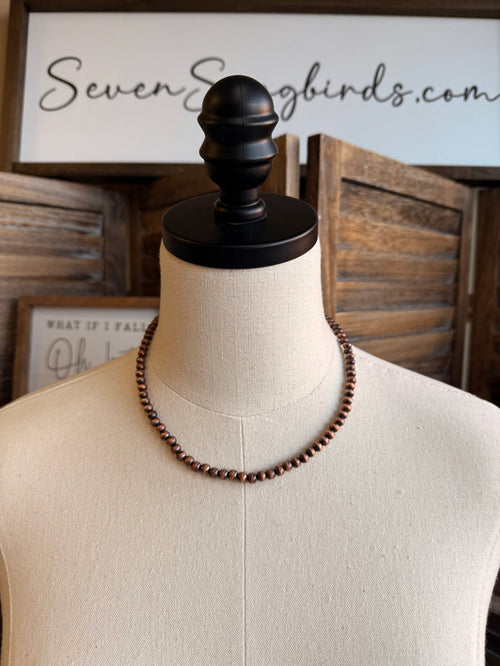 16-inch pearl bead necklace with copper-toned beads on mannequin display
