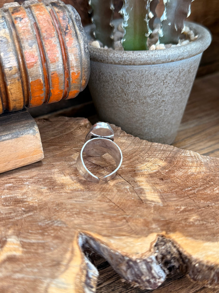 Adjustable silver-tone ring with oval green stone bezel