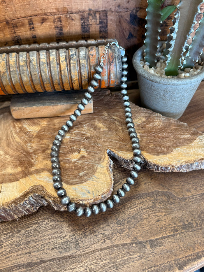 16-inch silver pearl bead necklace, close view of round silver pearls in loop.