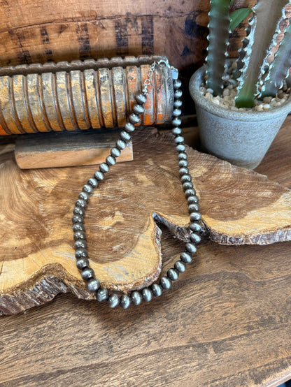 16-inch silver pearl bead necklace, close view of round silver pearls in loop.