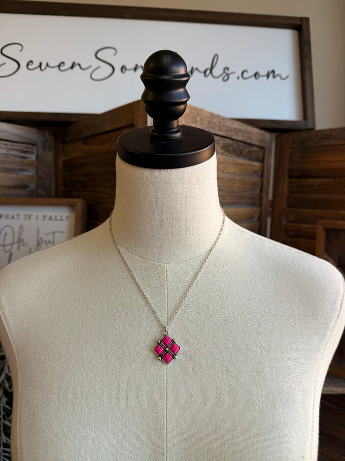 Diamond four-stone necklace with a pink square pendant on a silver chain