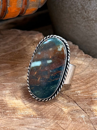 Adjustable oval stone ring, blue-green cabochon with beaded edge on silver band