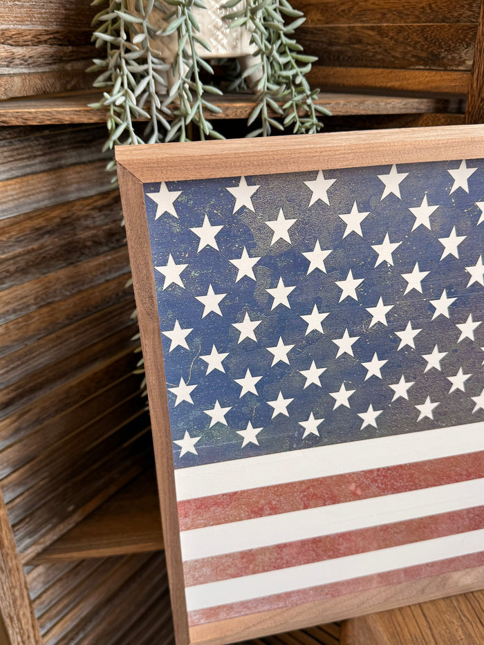 Close-up of framed American flag artwork with blue stars and red-and-white stripes
