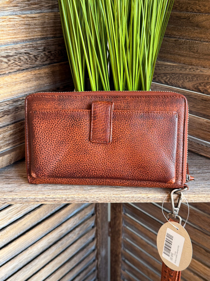 Rusty brown leather wristlet wallet with front seam panel and metal zipper pull