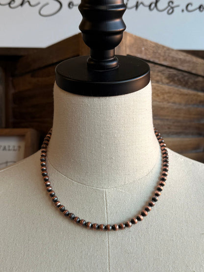 Genuine copper bead necklace with small round beads, centered on a mannequin
