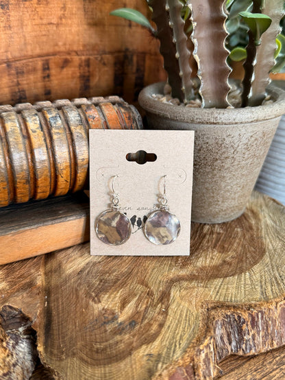 Sterling silver fishhook earrings with hammered round slab discs on display card