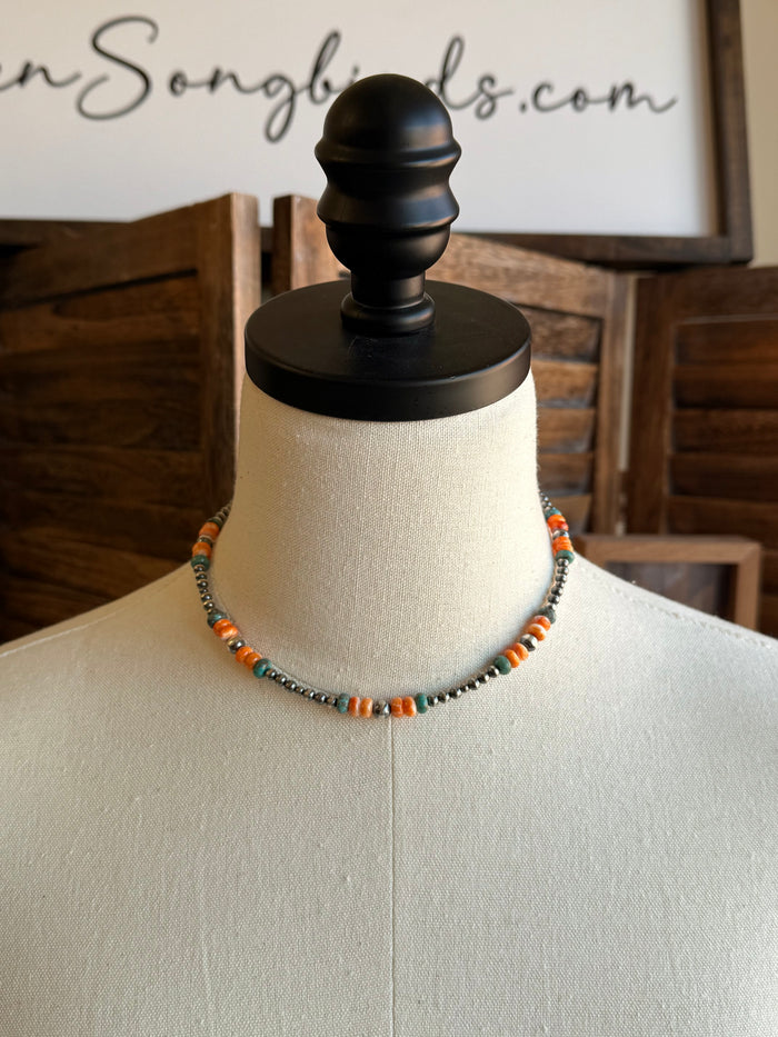 Beaded necklace with turquoise and orange beads and silver-tone accents