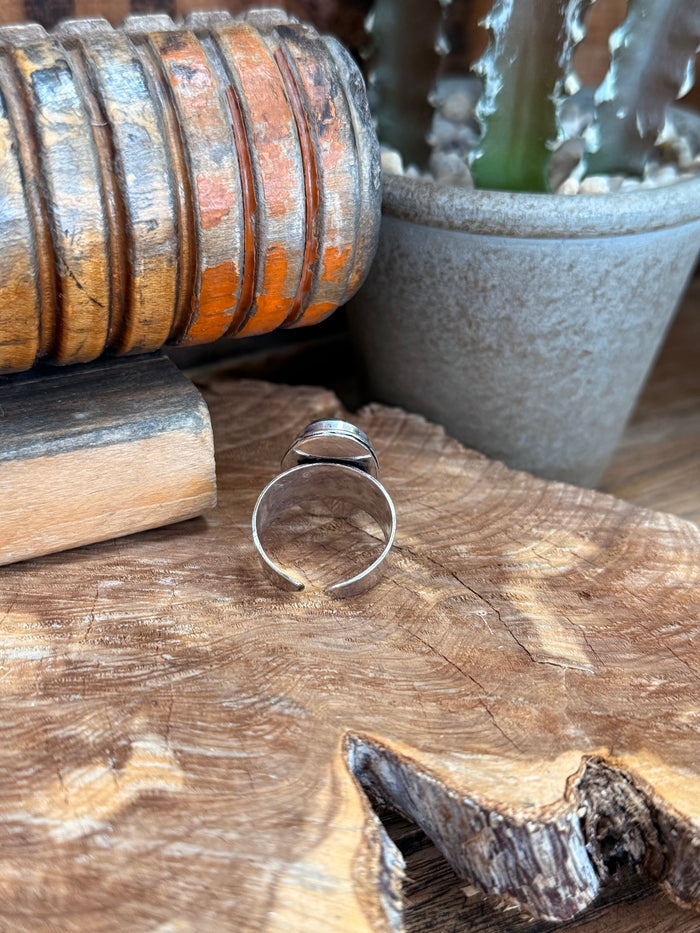 Adjustable silver-tone open band ring with oval blue stone top view