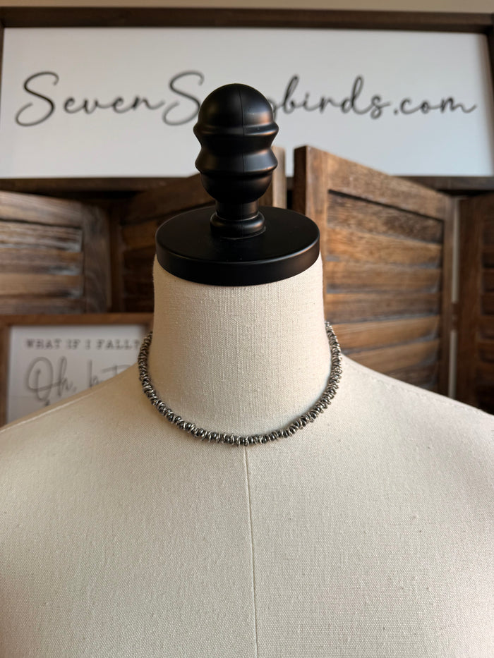 Silver pearl mixed bead necklace with one visible beaded row on mannequin