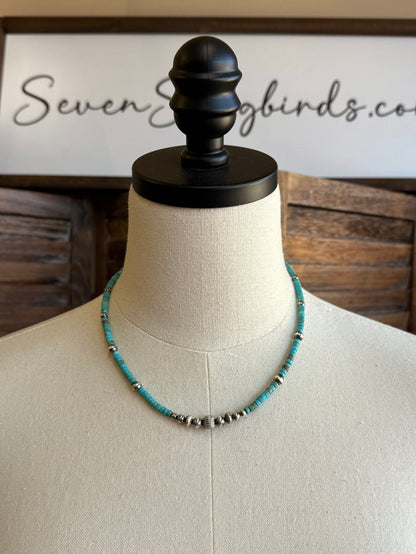 Blue turquoise heishi bead necklace on a mannequin with silver spacer beads