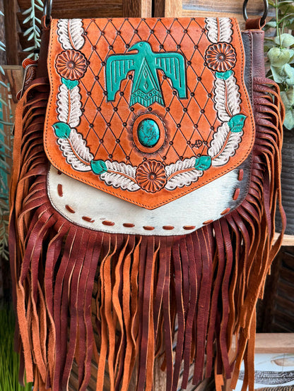 Fringed cowhide crossbody purse, orange flap with turquoise Thunderbird centerpiece