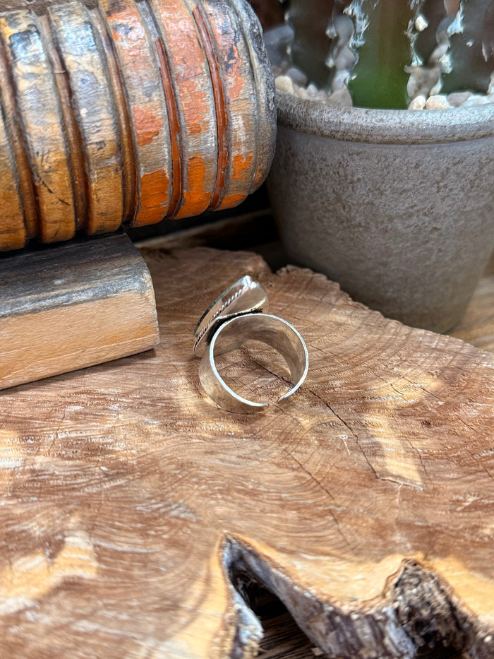 Silver-toned adjustable ring with open back and teardrop stone edge
