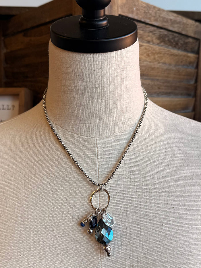 Silver chain necklace with hoop link and blue crystal cross charm