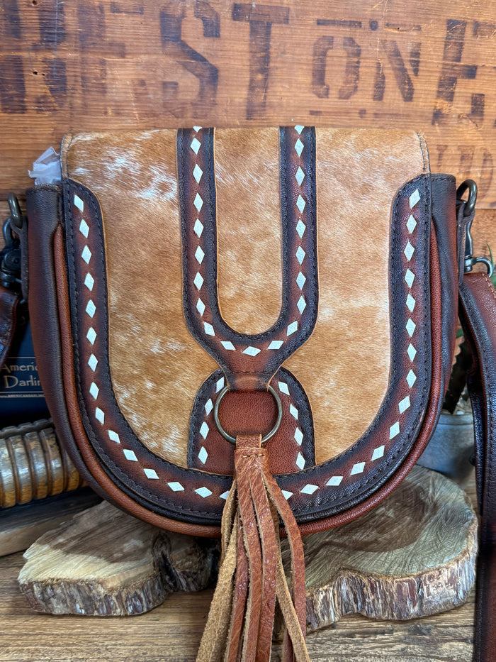 Brown cowhide flap crossbody bag with horseshoe ring clasp, white diamond trim, fringe tassel