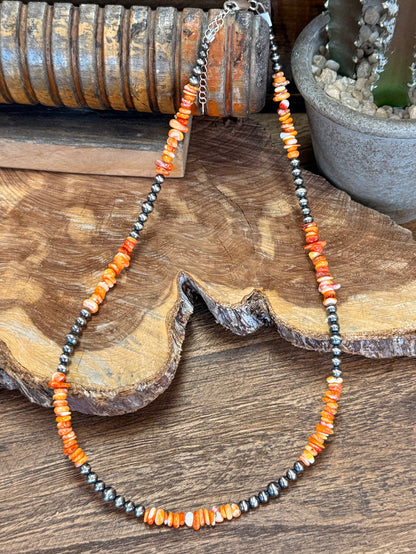 Orange spiny oyster chip bead necklace, silver-tone beaded strands on wood