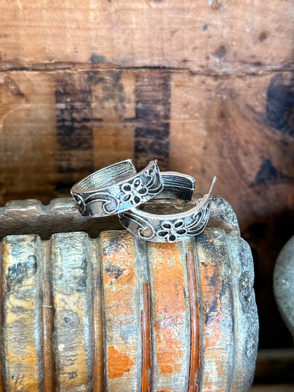 Silver floral engraved hoop stud earrings with ornate scrollwork on the hoops