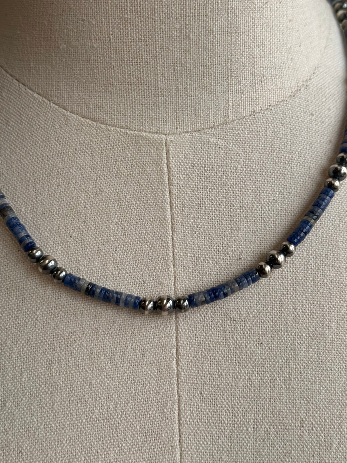 Close-up of blue sodalite heishi beads with silver spacers and round pearls