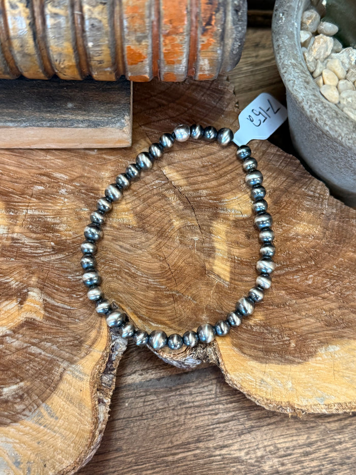 Silver pearl beaded stretchy bracelet shown centered with full bead circle
