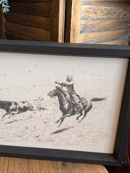 Close-up cowboy roping longhorn line art in dark gray framed artwork