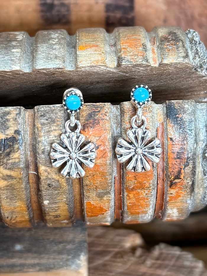 Silver-tone dangle earrings: turquoise cabochon tops with sunburst flower charms