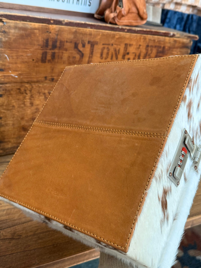 Tooled tan leather jewelry box side panel with hair-on cowhide trim and latch hardware