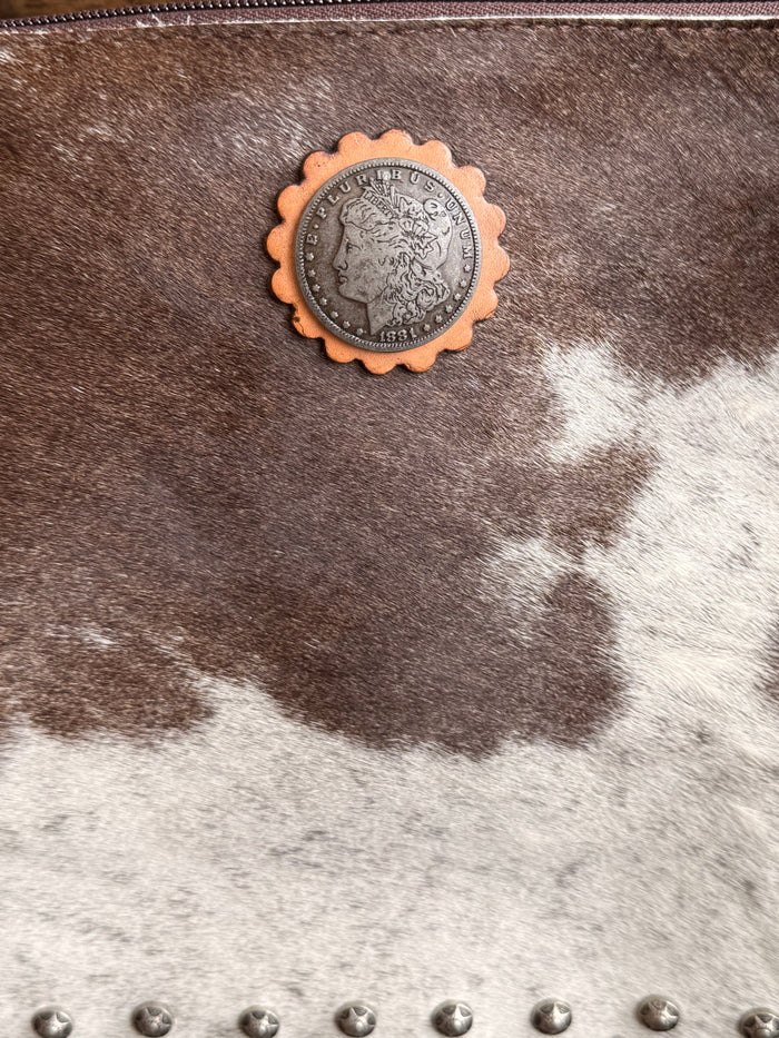 Cowhide coin crossbody purse with round metal concho and silver stud detail