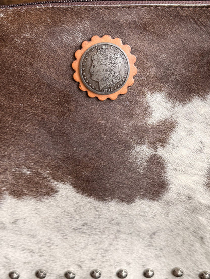 Cowhide coin crossbody purse with round metal concho and silver stud detail