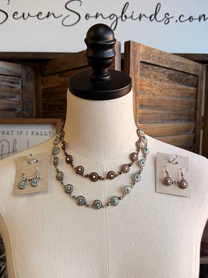 Copper-toned concho jewelry set with layered necklace and stud earrings, turquoise stones