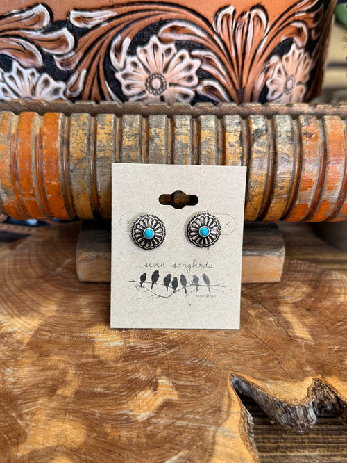 Silver-tone round concho stud earrings with turquoise center, pair on card