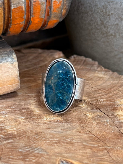 Adjustable silver-tone ring featuring a large oval blue natural stone face
