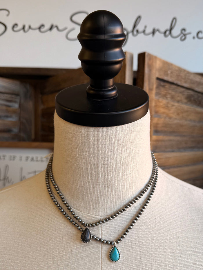 Silver-tone bead choker with dark center charm and two turquoise teardrop charms