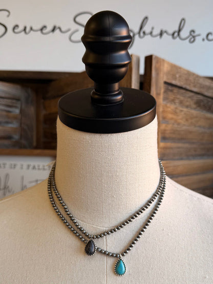 Silver-tone bead choker with dark center charm and two turquoise teardrop charms