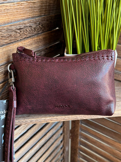 Plum mini wristlet bag with top zipper, wrist strap, and embossed logo