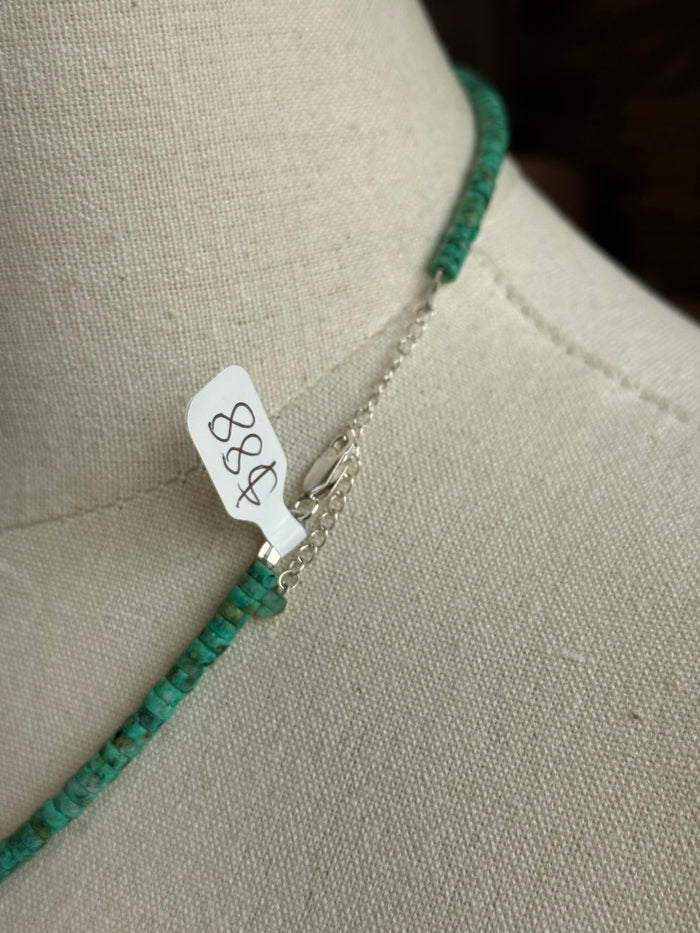 Sterling clasp on turquoise heishi necklace with small pearl bead detail