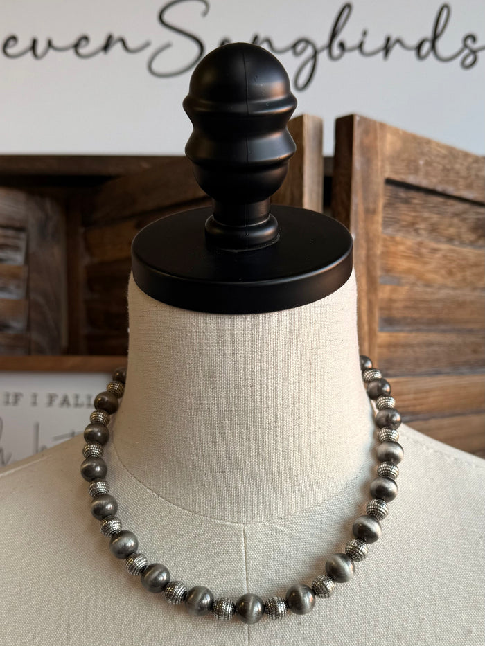 Silver pearl bead necklace with evenly spaced round gray beads and black clasp