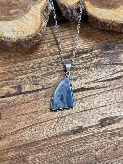 Blue triangular stone pendant on silver chain necklace