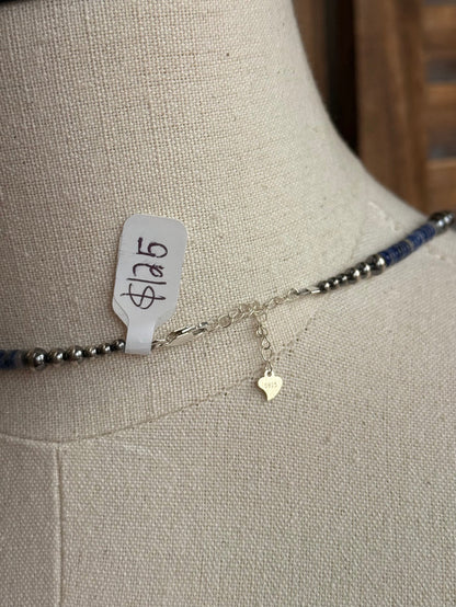 Sterling clasp detail with small pearl charm on blue sodalite heishi strand