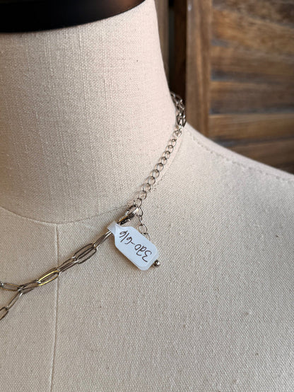 Silver double-layer chain necklace with small engraved charm tag