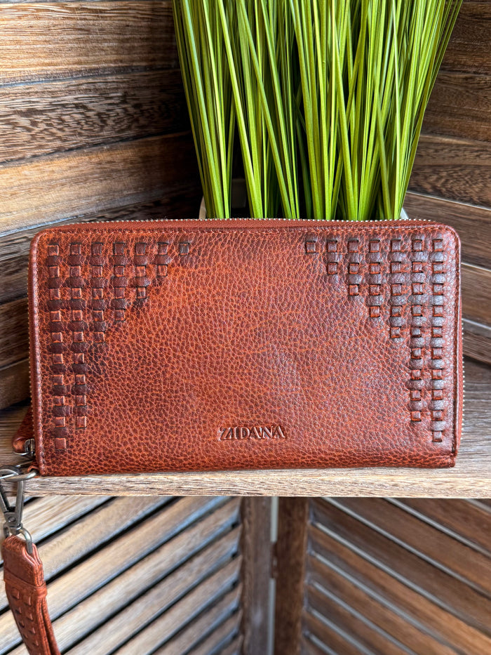 Rusty brown zip wristlet wallet with embossed texture and stitched edge detail