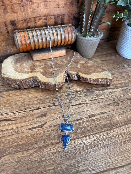 Silver lariat necklace with blue stone oval and teardrop pendants on long chain