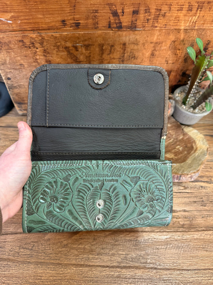 Turquoise and dark leather wallet with two snap flaps and embossed floral panels