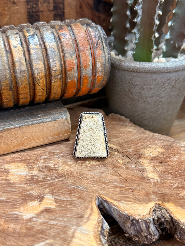 Adjustable silver-tone ring with rectangular speckled stone in a metal frame