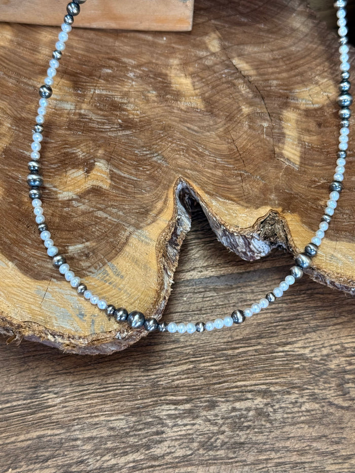 Freshwater pearl choker necklace with close-up light pearls and dark silver beads